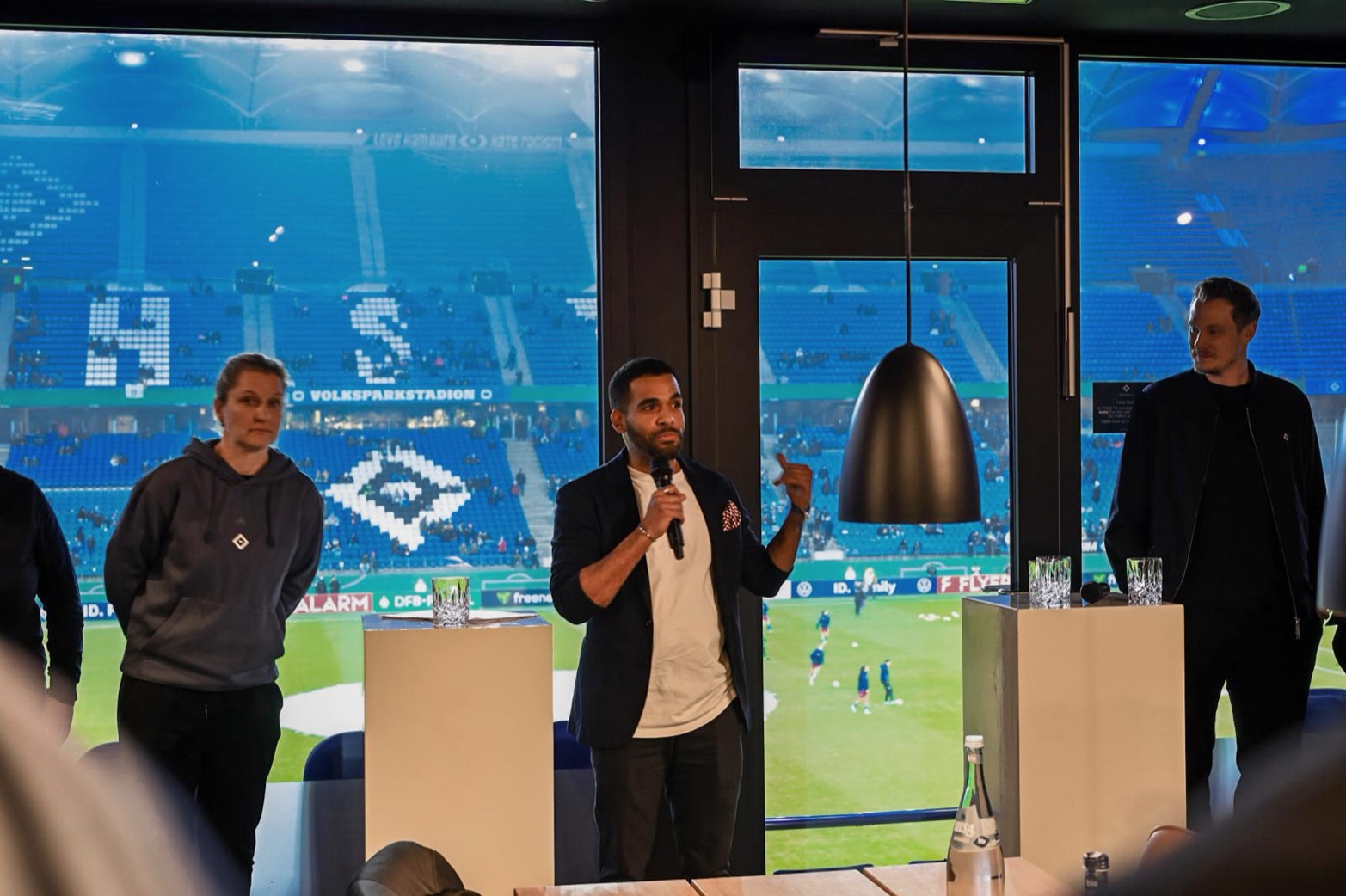 Ludwig Amuam hosting an event on stage at the Volksparkstadion in Hamburg