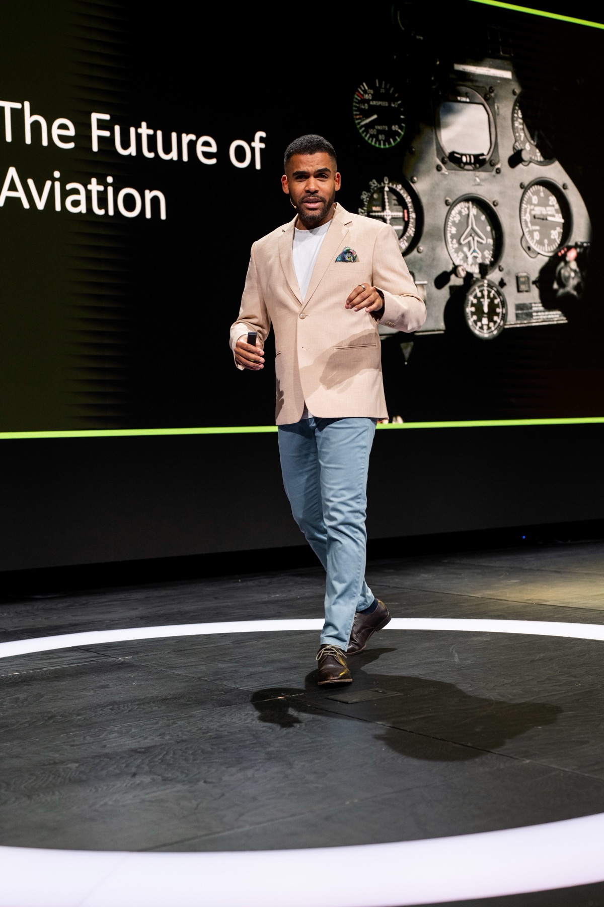 Ludwig Amuam hosting a corporate conference on stage, presenting on the future of aviation